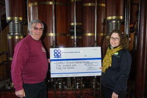 Derek Goodman, director and volunteer co-ordinator of Claymills Pumping Engines Trust, receives the cheque for £555 from Marina Hutton, manager of Tamworth Co-op Stretton store, in one of the engine rooms. 