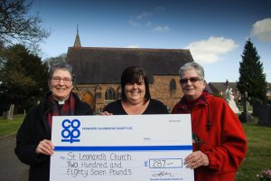Julie-Ann Kester, manager of Tamworth Co-op convenience store in Dordon, hands over the cheque for £287 to Rev Ann Simmons and church warden Susan Davis.