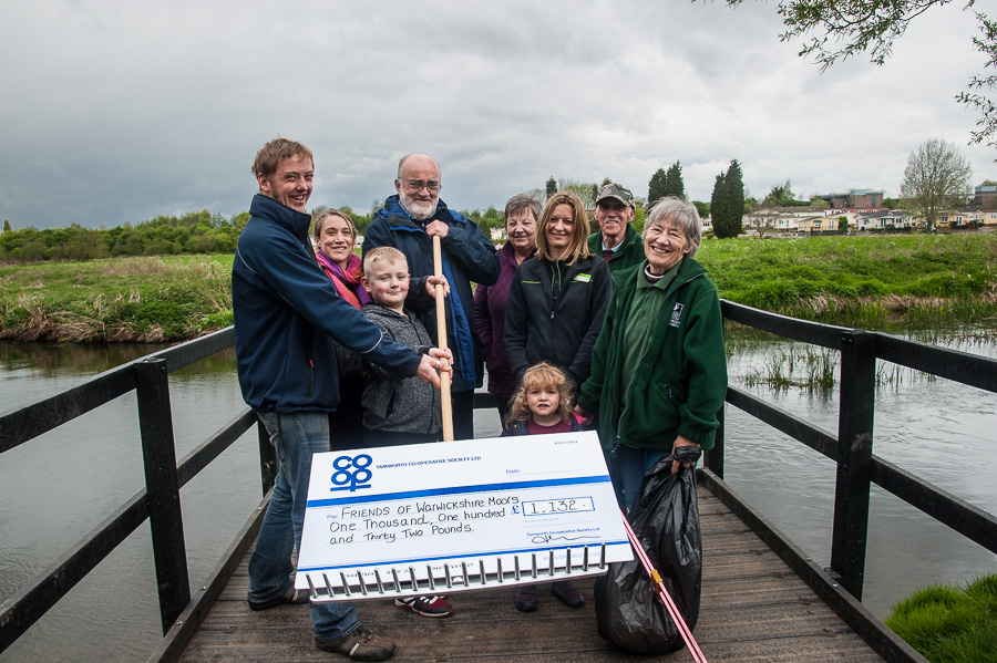 Jayne Cutforth, manager of Tamworth Co-op’s Bolehall convenience store, presenting cheque to Friends of Warwickshire Moor volunteers Lee Curtis, Suzi Clark, chairman Malcolm Sanford, Lesley and Tom Barker, and secretary Pam Clark, with young helpers Oscar Hatfull (9) and Elizabeth Clark (2).