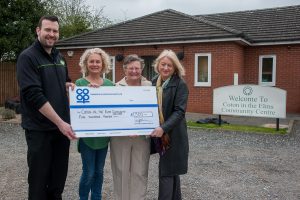 Neil Wakelin, manager of Rosliston Co-op, presents Community Dividend Fund cheque to Sam Towers, chairperson of Coton in the Elms Community Centre, with management committee member Margaret Parkes and trustee Peggy Proffer.