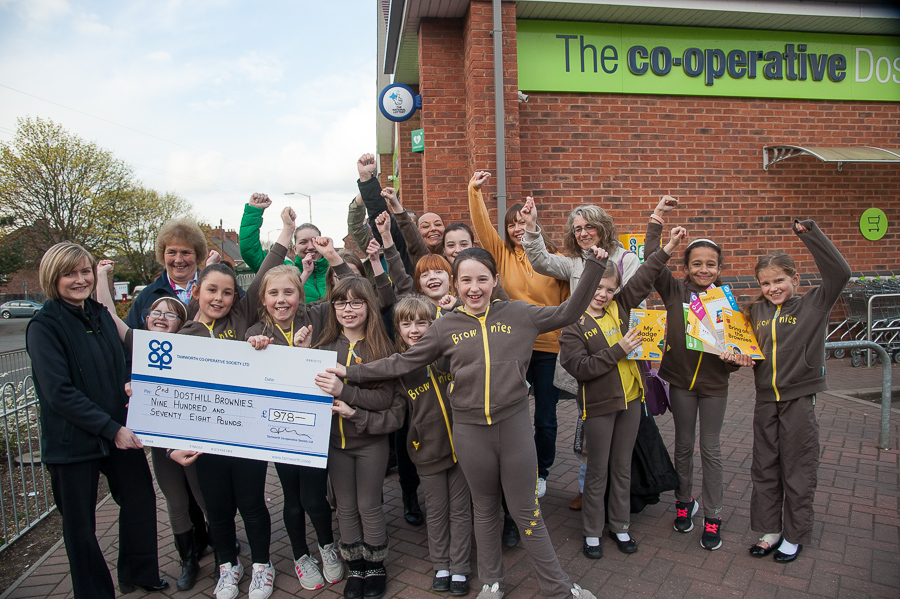 Vicky Freeman, manager of Dosthill Co-op, presents cheque for £978 to overjoyed 2nd Dosthill Brownies and their leader Jill Longhurst.