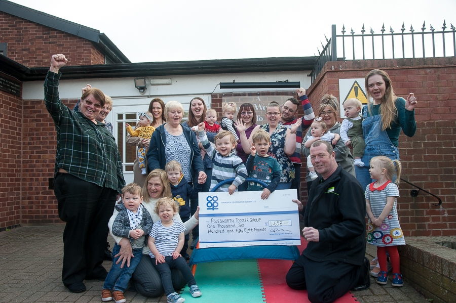 Sebastian Pirrie and Rory Broderick, who have attended Polesworth Toddler Group since babies and are leaving in September 2019, accept Community Dividend Fund cheque from Karl Vyse, manager of Polesworth Co-op. Celebrating with them are volunteers and parents from group