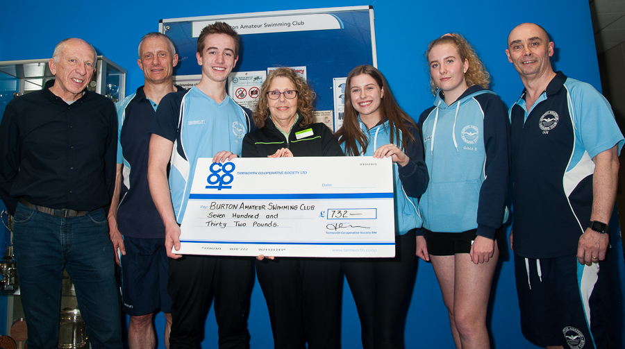 Pictured handover of Community Dividend Fund cheque are members of Burton Amateur Swimming Club with Marina Hutton, manager of Stretton Co-op. 