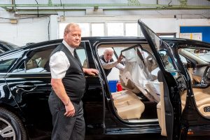 Funeral director Paul Warwick and funeral co-ordinator Trevor Palmer fit a new screen in one of Tamworth co-op's limousines