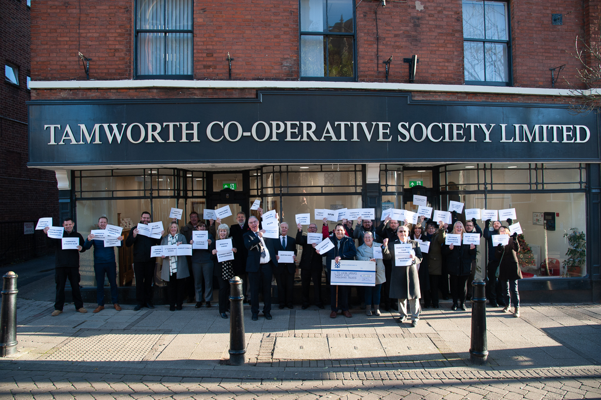 Tamworth Co-op staff hold signs with names of groups benefiting from 70 for 70 Community Donation.